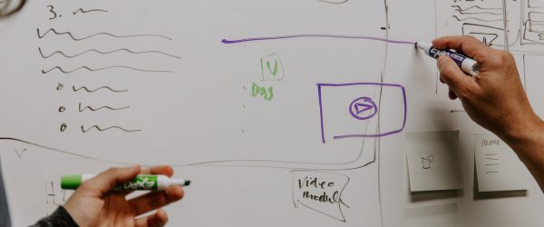 kaleidico-26MJGnCM0Wc-unsplash two people drawing on whiteboard