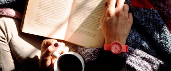person-reading-book-and-holding-coffee-1550648 person-reading-book-and-holding-coffee